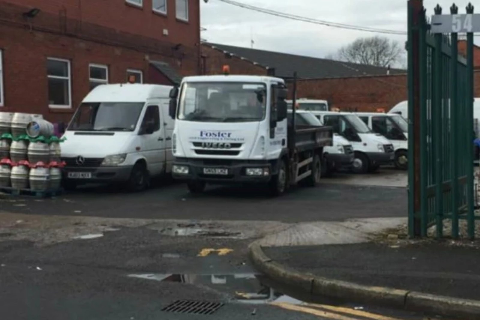 Foster branded vans and tipper wagon parked at the company yard