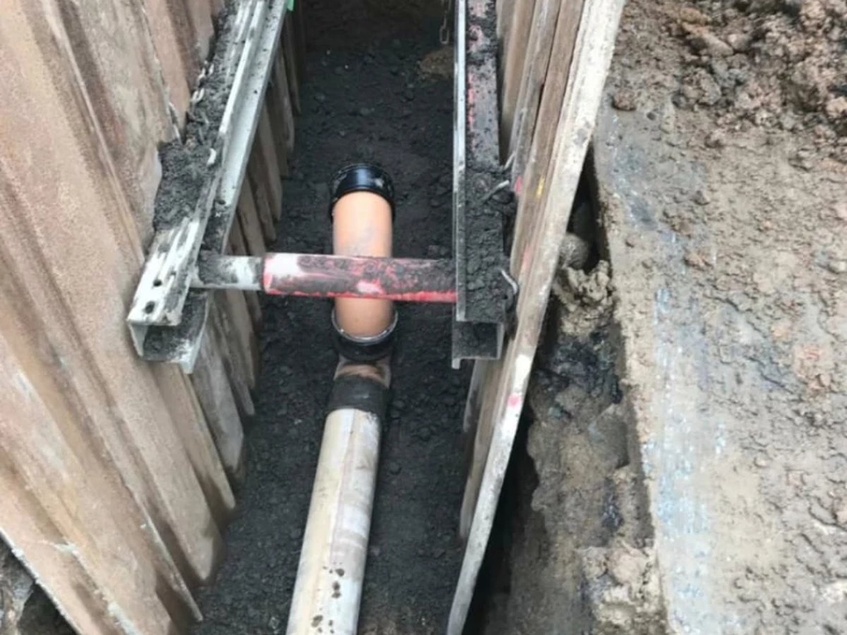 Drainage pipe bedded in a shored trench by Foster Civil Engineering