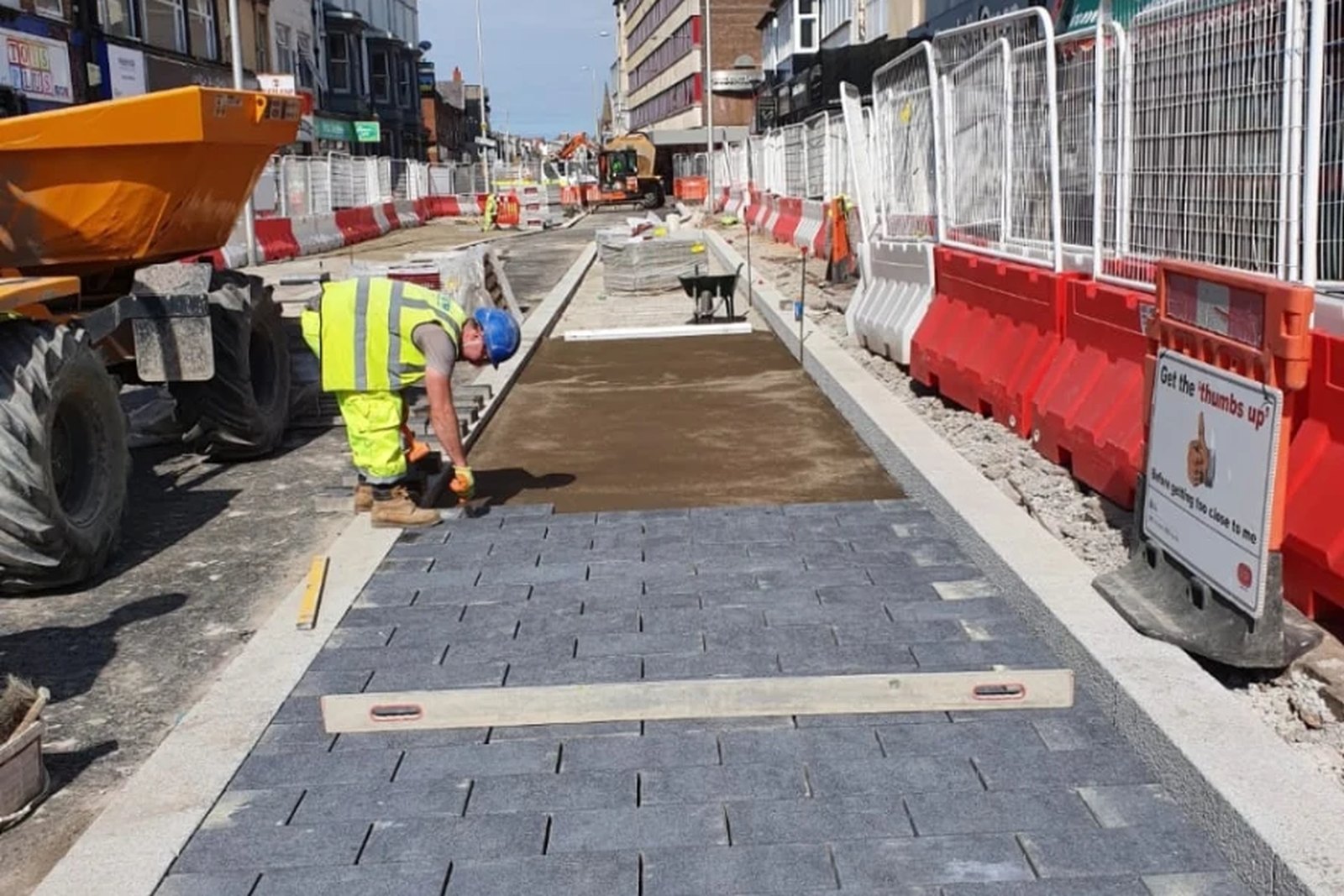 Block paved footway and new kerb line being laid on a pedestrianised town centre street
